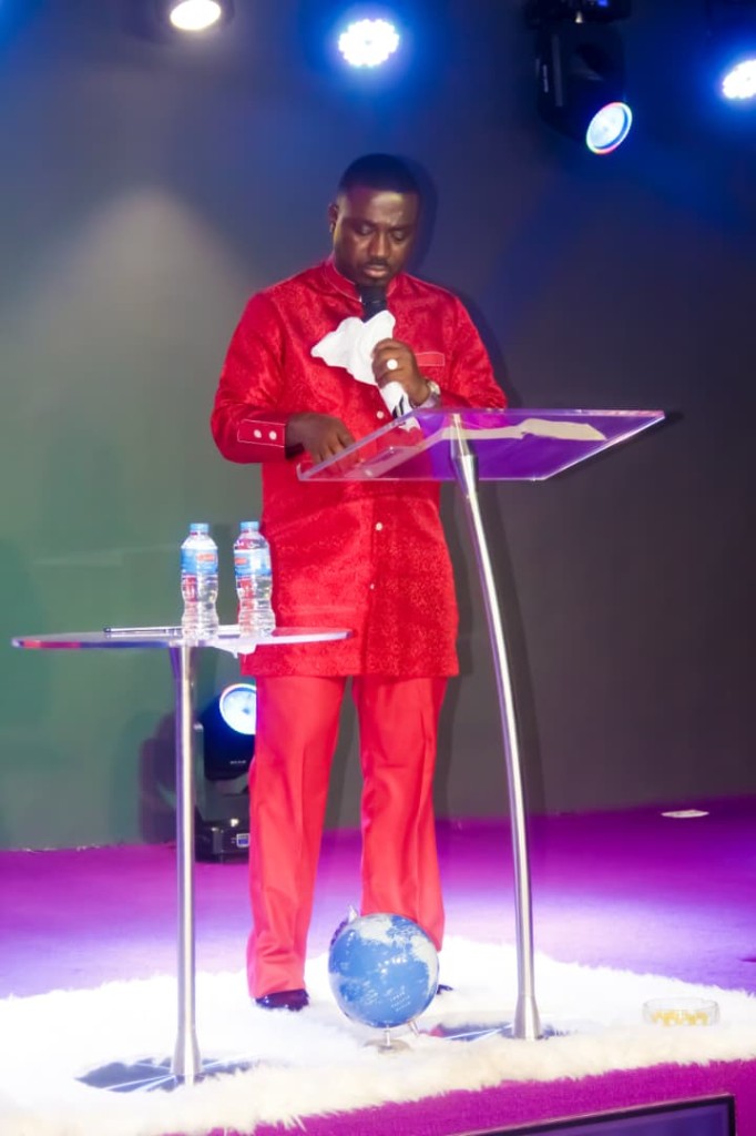 Bishop ministering from the pulpit at Emet House Chapel